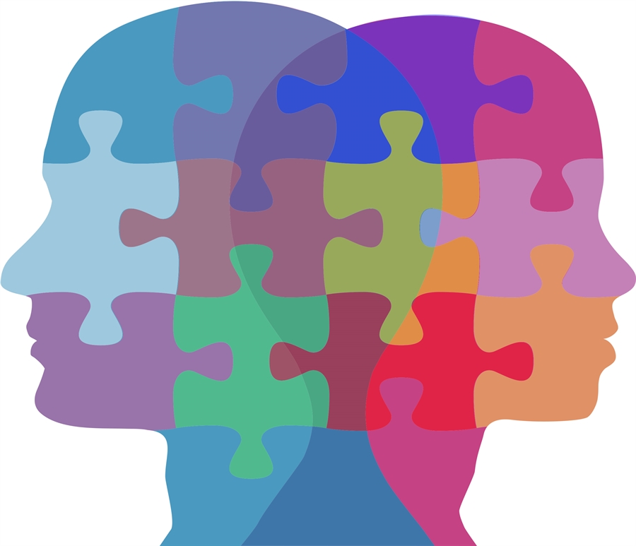 Two individuals with colorful puzzle pieces representing thoughts and ideas integrated into their heads.