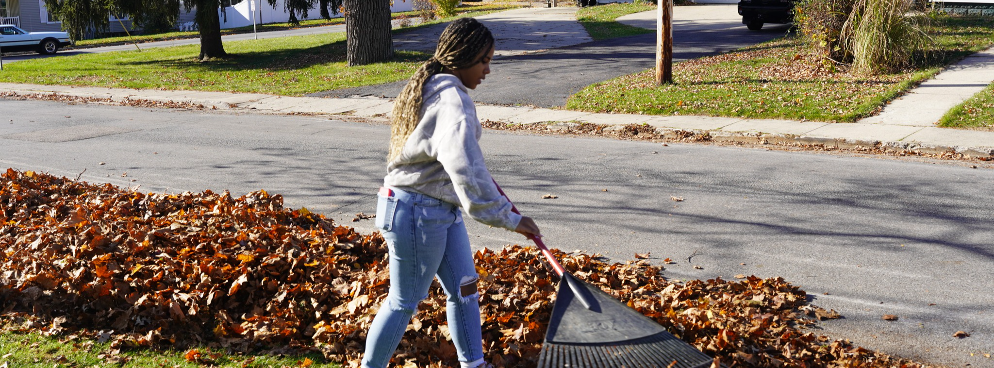 Student raking leaves