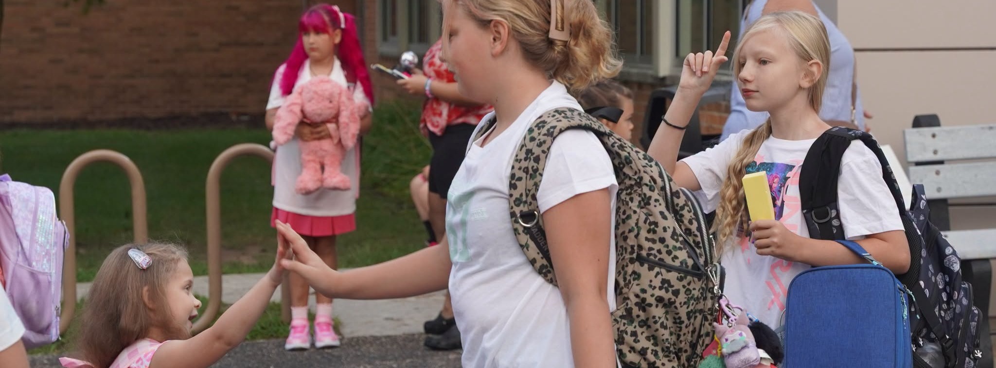 two school-aged children exchange a high-five