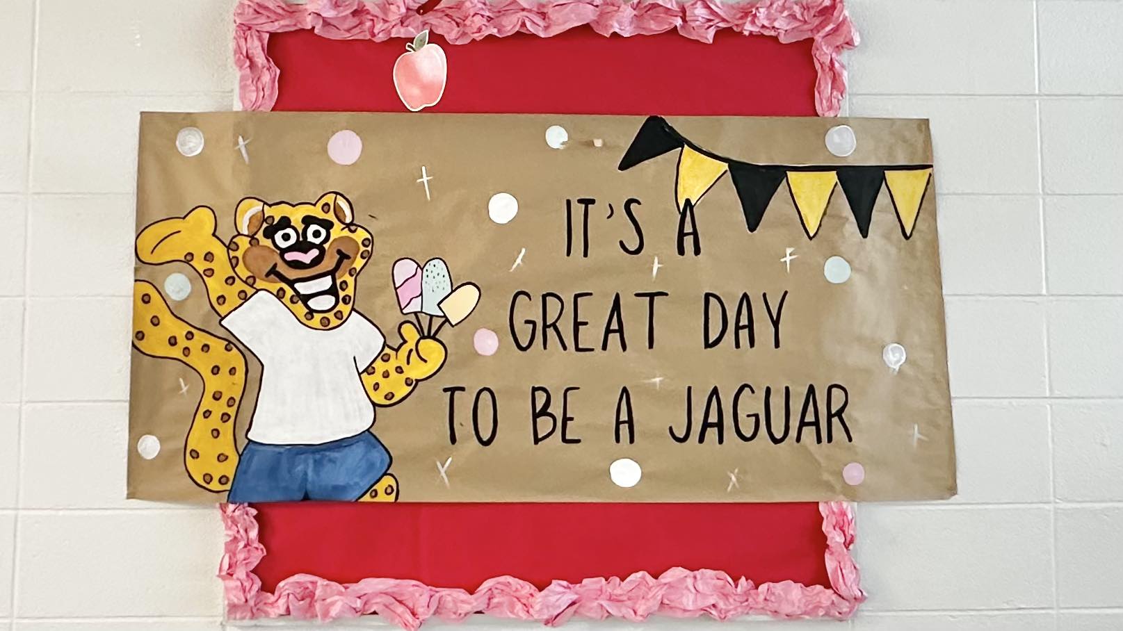 Mascot holding sign It's a Great Day to be a Jaguar
