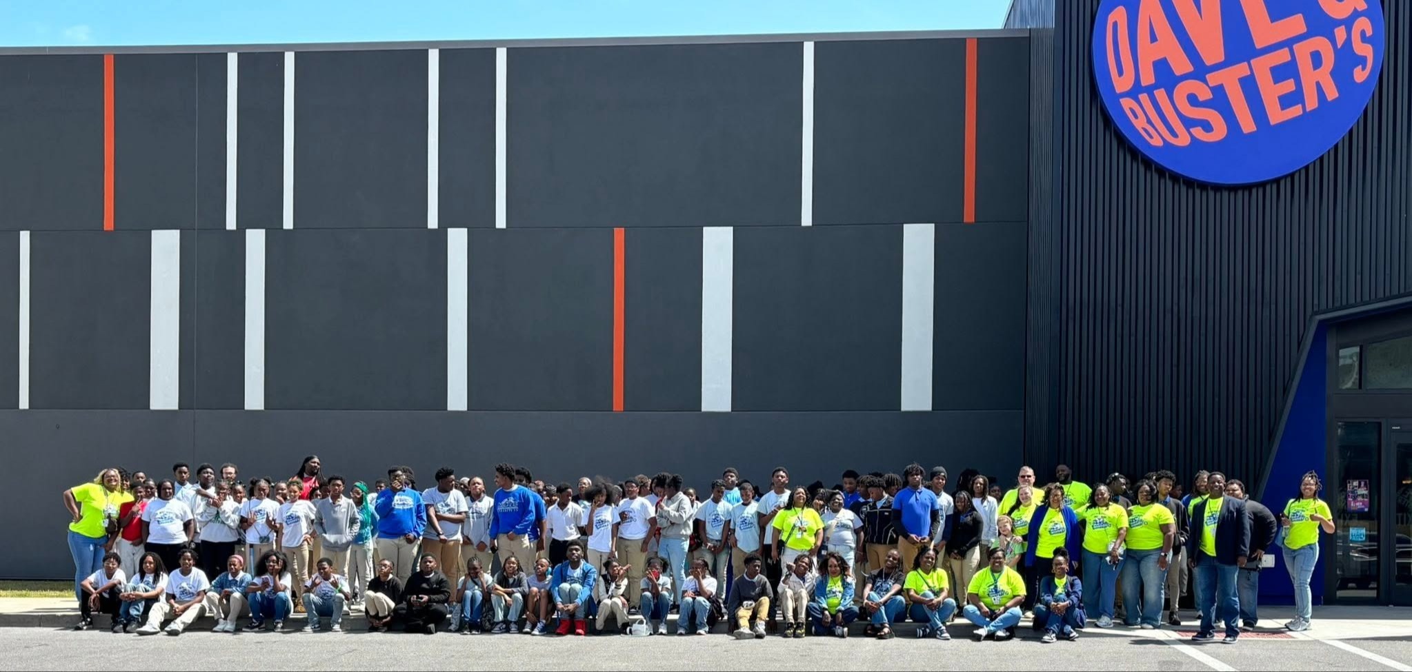 All students and staff  standing outside of DAVE'S BUSTERS.