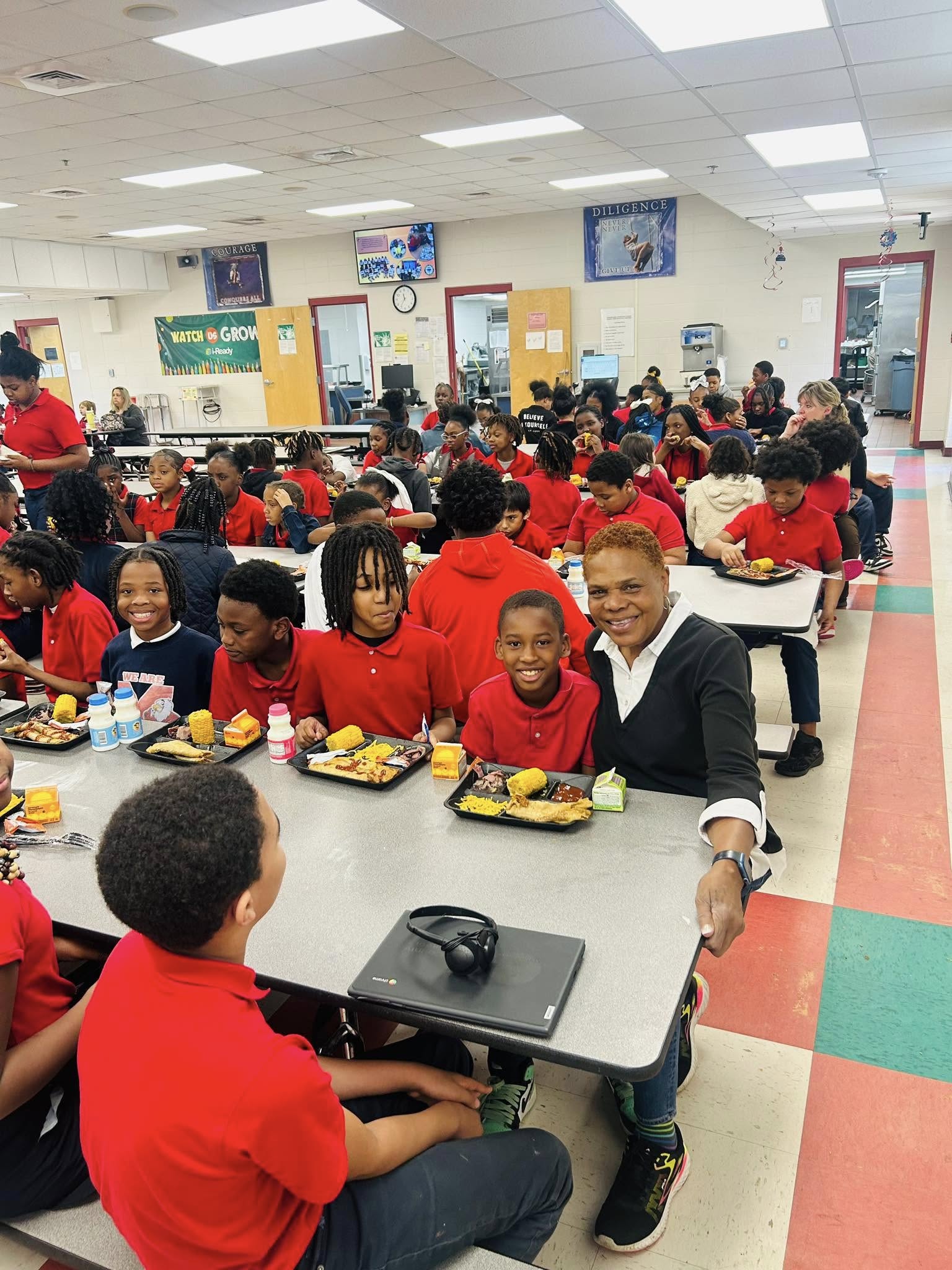Board member Sherry McDade with students