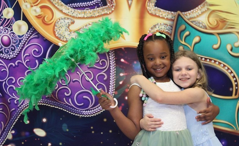 Two students posing with a parasol at the Sneaker Ball