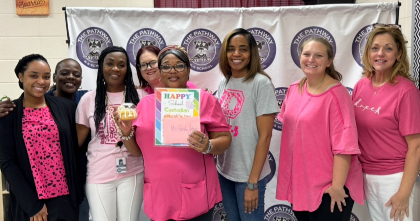 Teachers gather to celebrate the school custodian for national custodian day