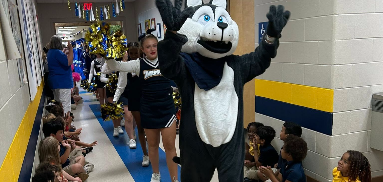 Taylor-White cheerleaders in hallway parade