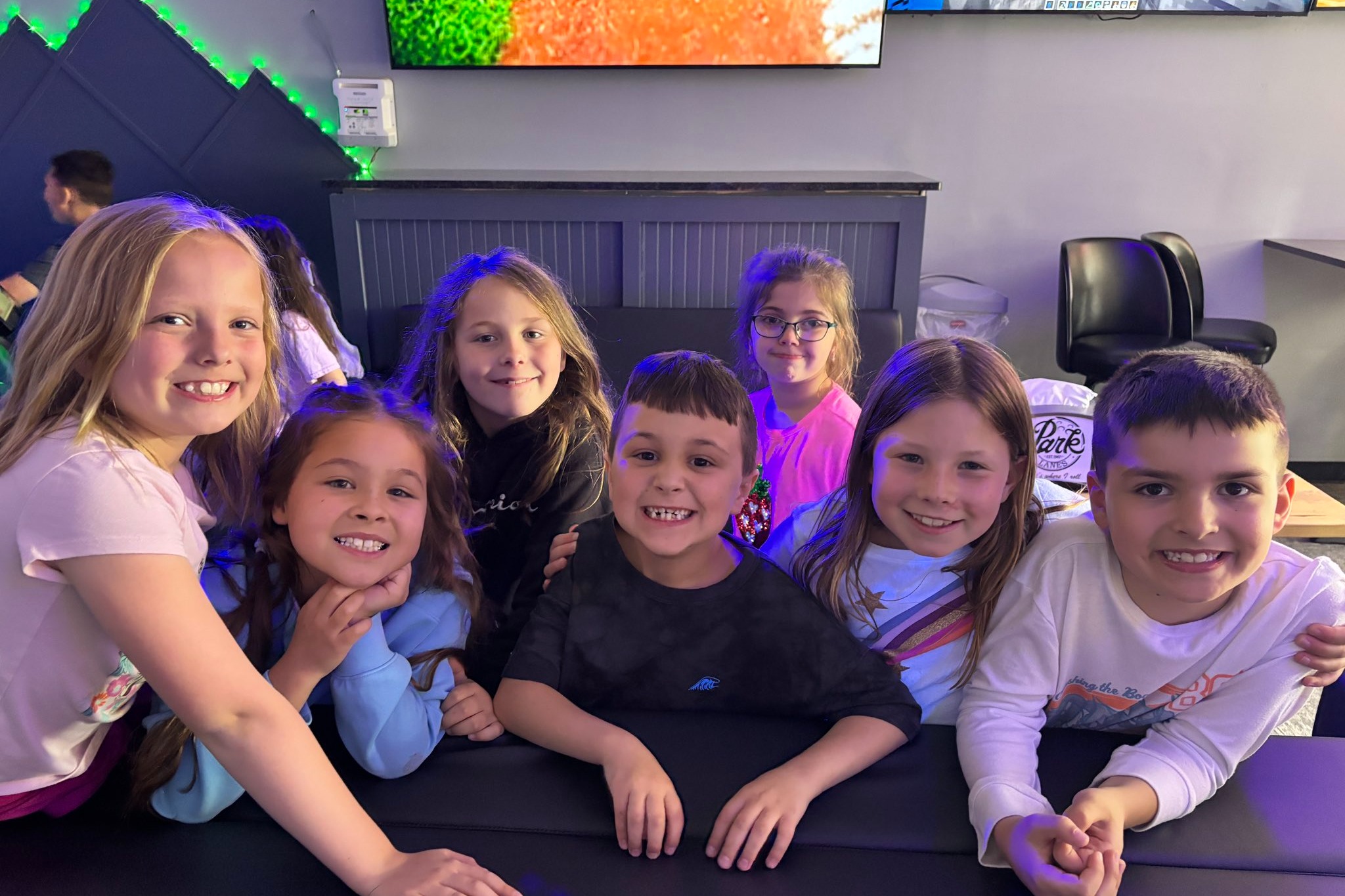Students smiling and happy at the bowling alley
