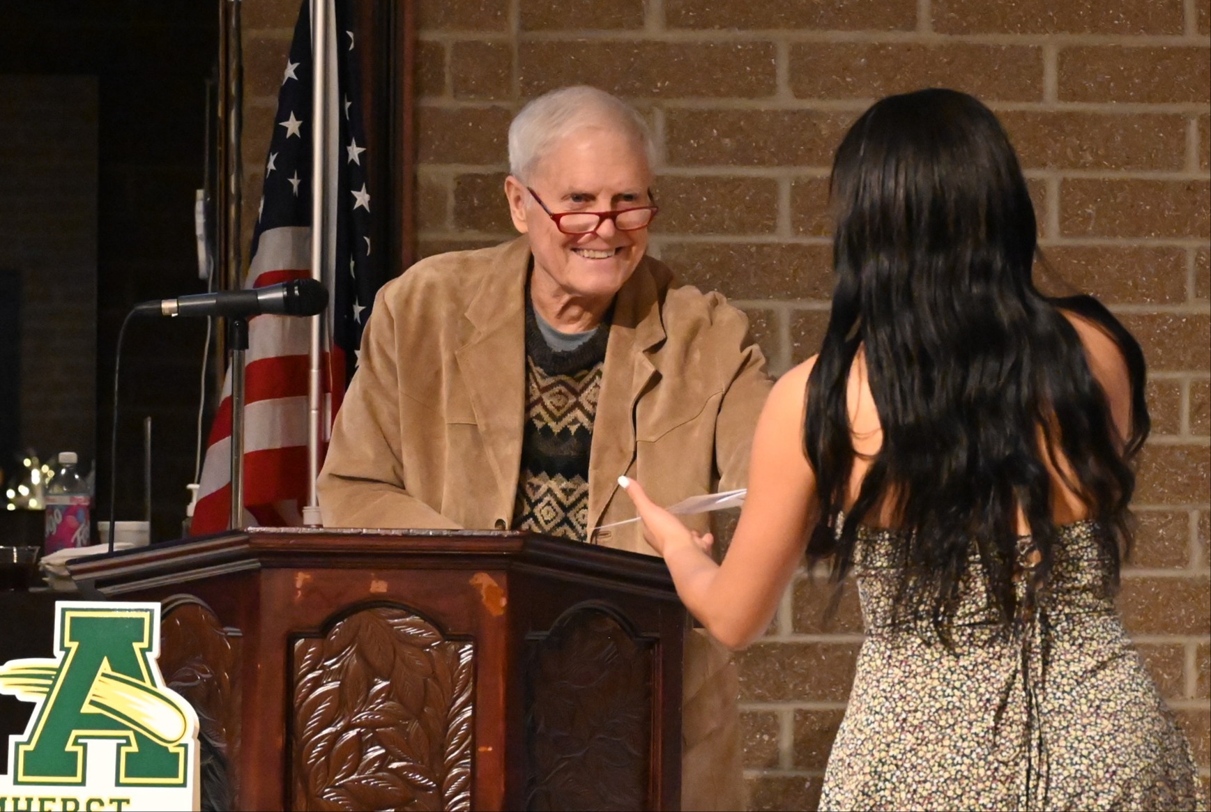 Dr. Schaffer handing out a scholarship to a student