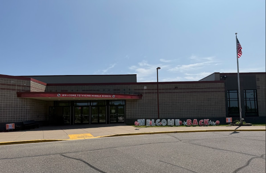 Viking Middle School front entrance with yard signs that spell out 'Welcome Back'