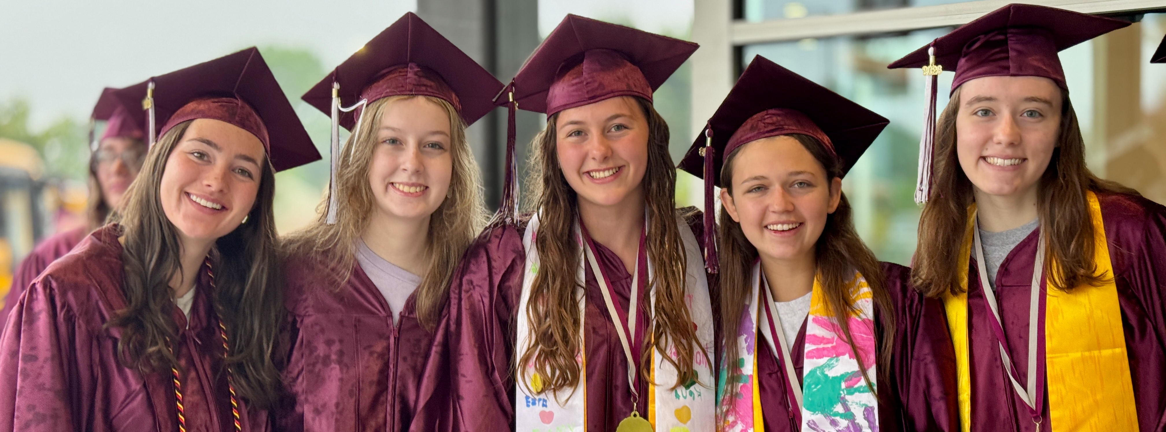 A group of students in graduation caps and gowns.