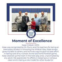 A young student receives an award on stage, surrounded by teachers, celebrating his efforts and positive impact at school.