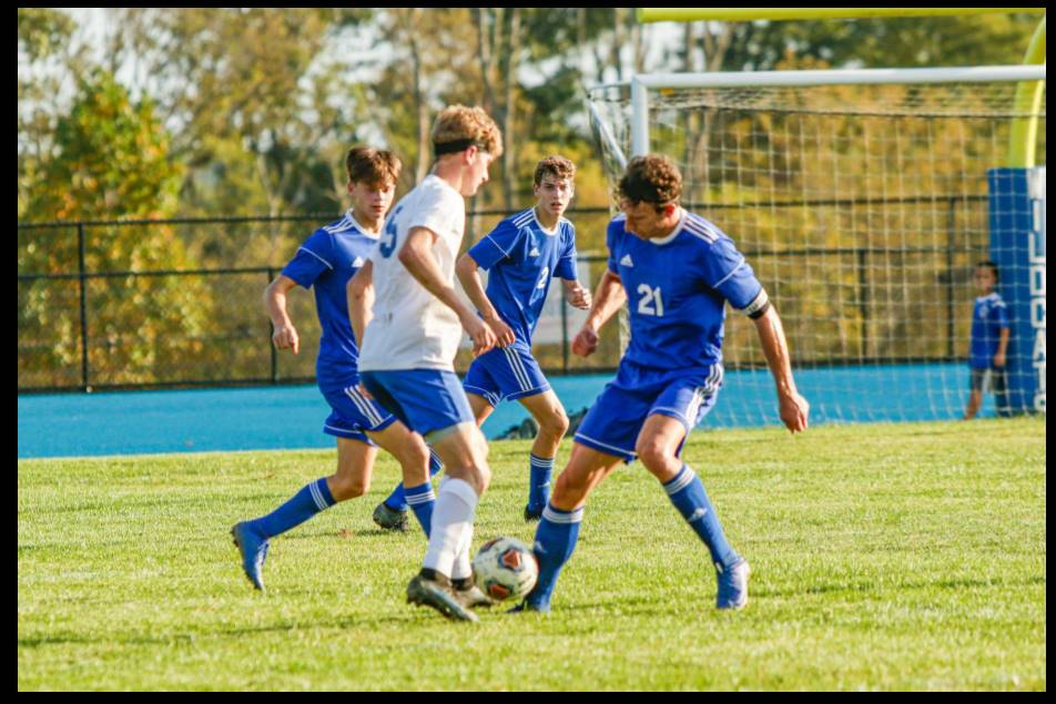 Boys soccer match featuring teams competing against Cedarville on the field.