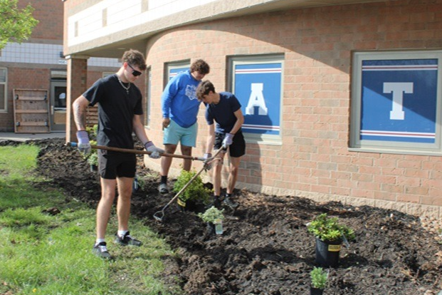 kids working on flowerbed