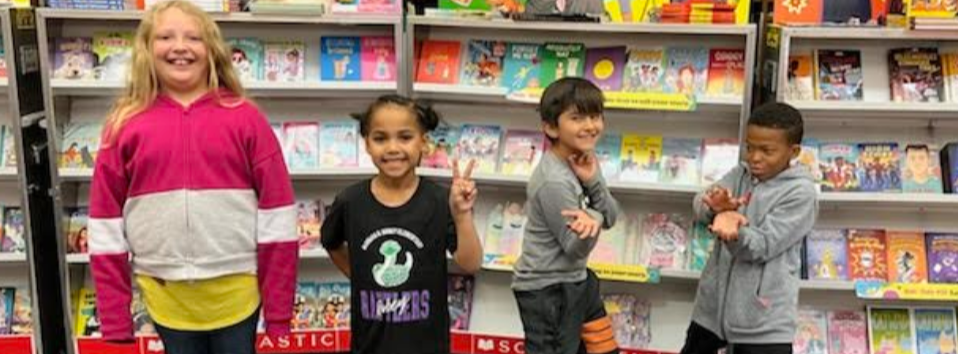 Students standing with prize book baskets that they won