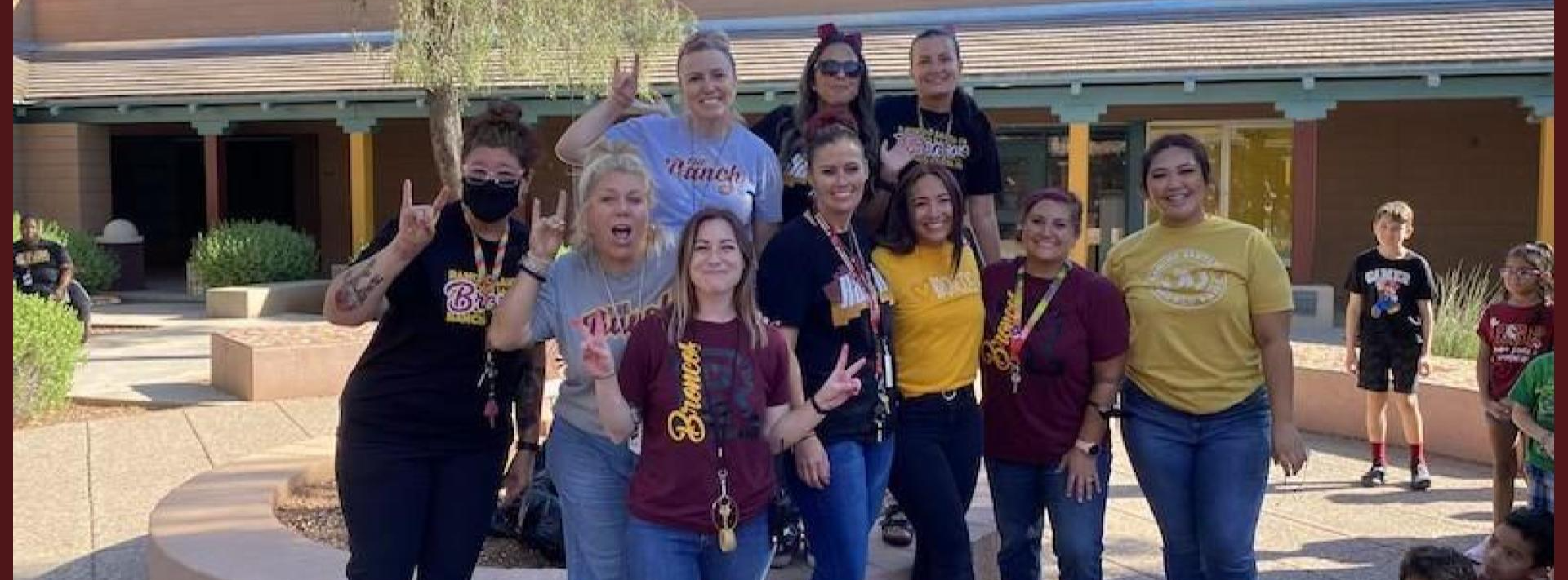 A group of teachers pose together after getting hair-sprayed for raising money for the fundraiser