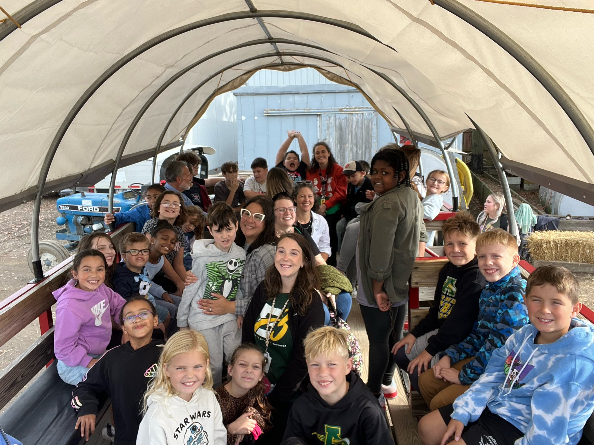 Students on a covered wagon during a field trip! 