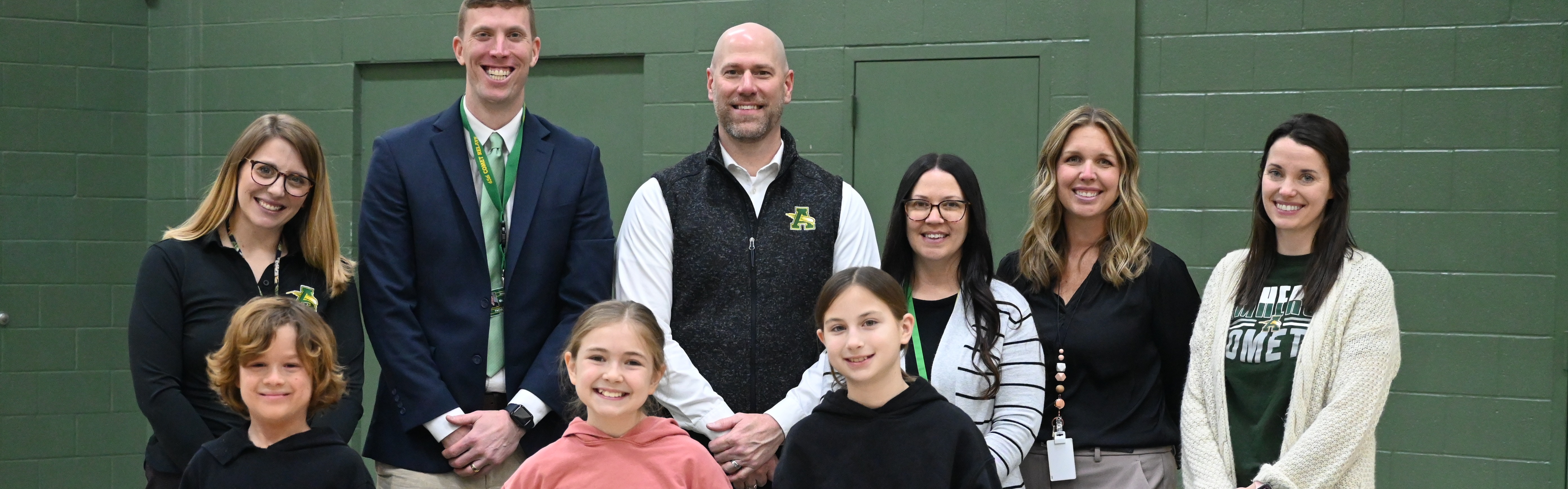 4th Grade Spelling Bee Winners pose in a picture with administration and spelling been judges