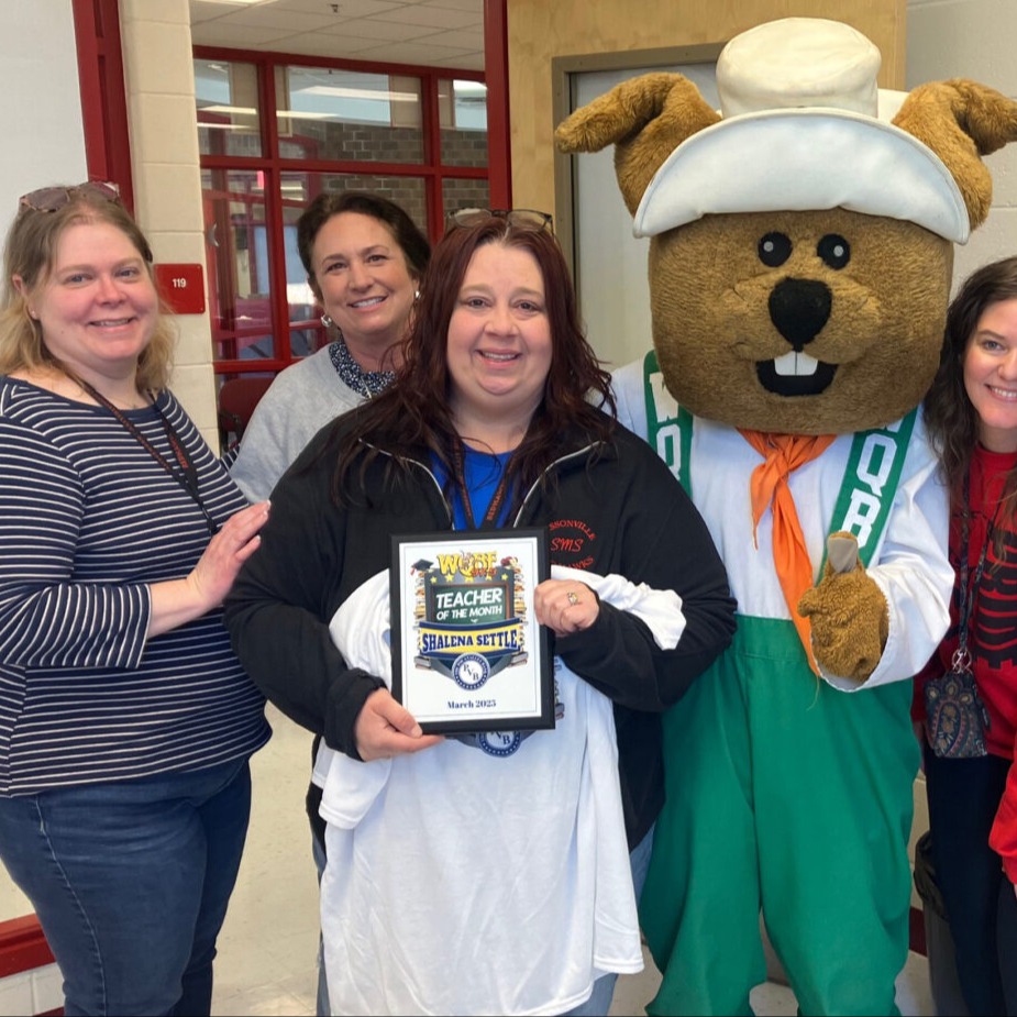 sissonville middle school teacher posing with her teacher of the month award