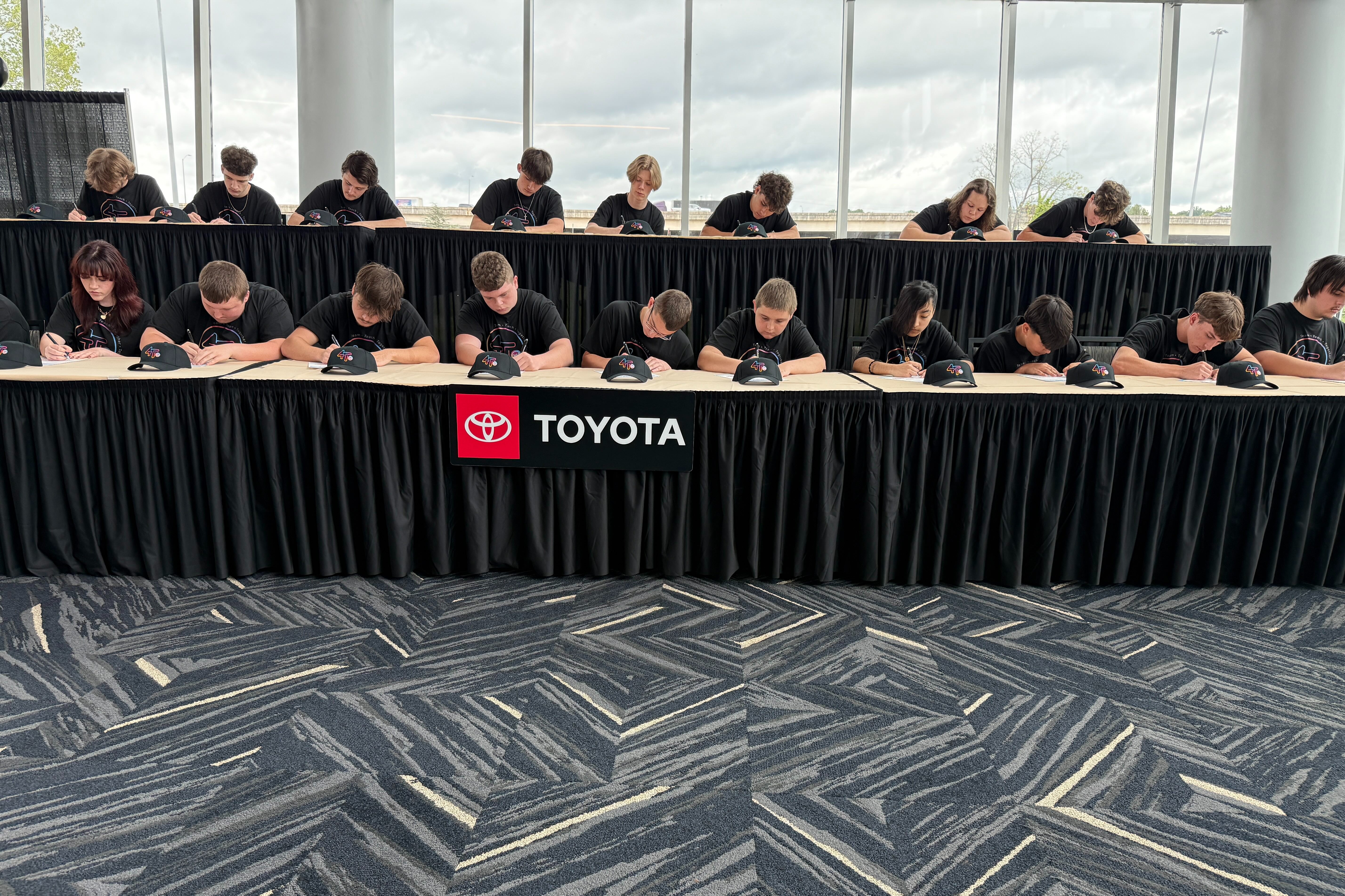high school students at the civic center signing their offer letters to join Toyota's 4T program.