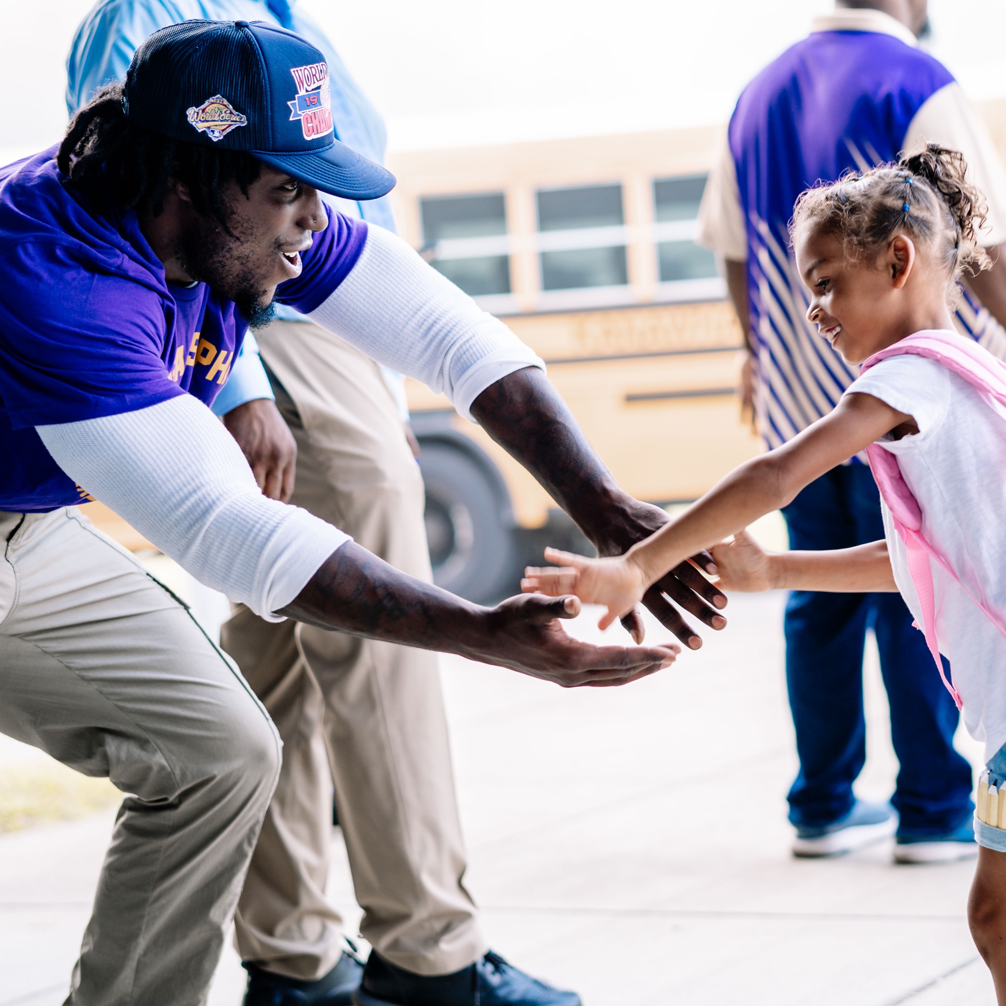 teacher giving a student a high five on the first day of school.