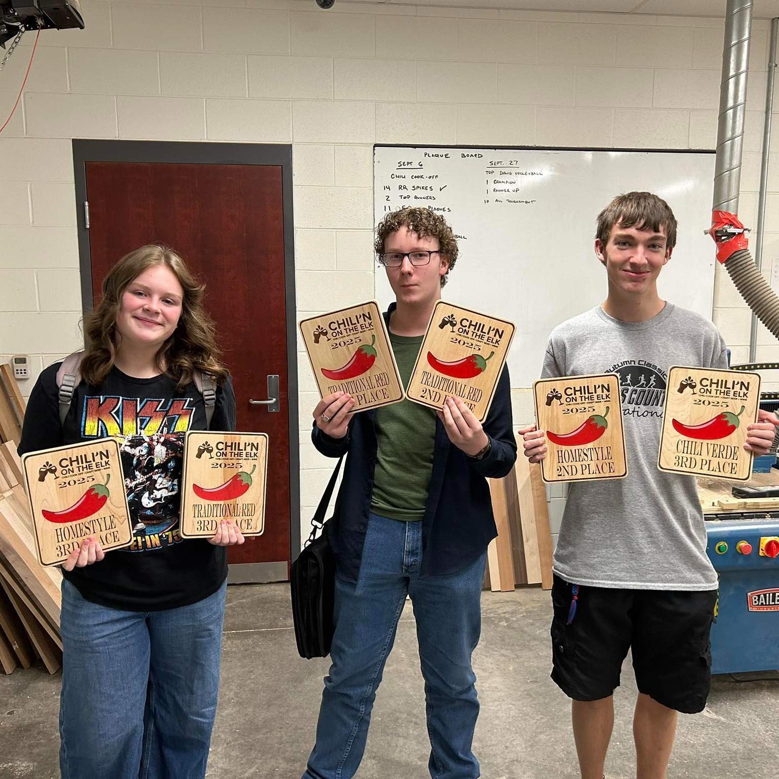 herbert hoover high school students in the wood shop class showing the plaques they made for a chili cookoff event.