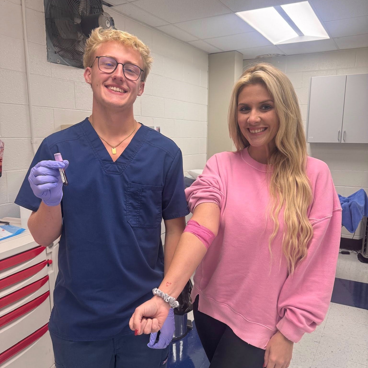 ben franklin student posing with teacher after completing his first successful blood draw.