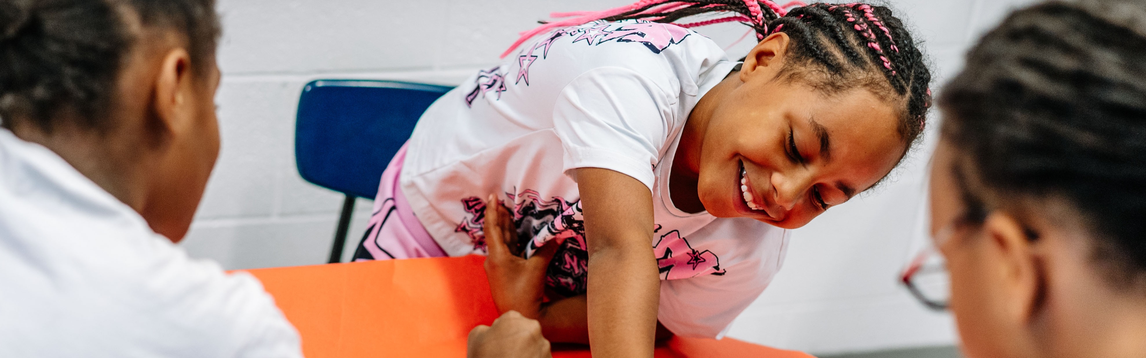 kcs students laughing during an art lesson.