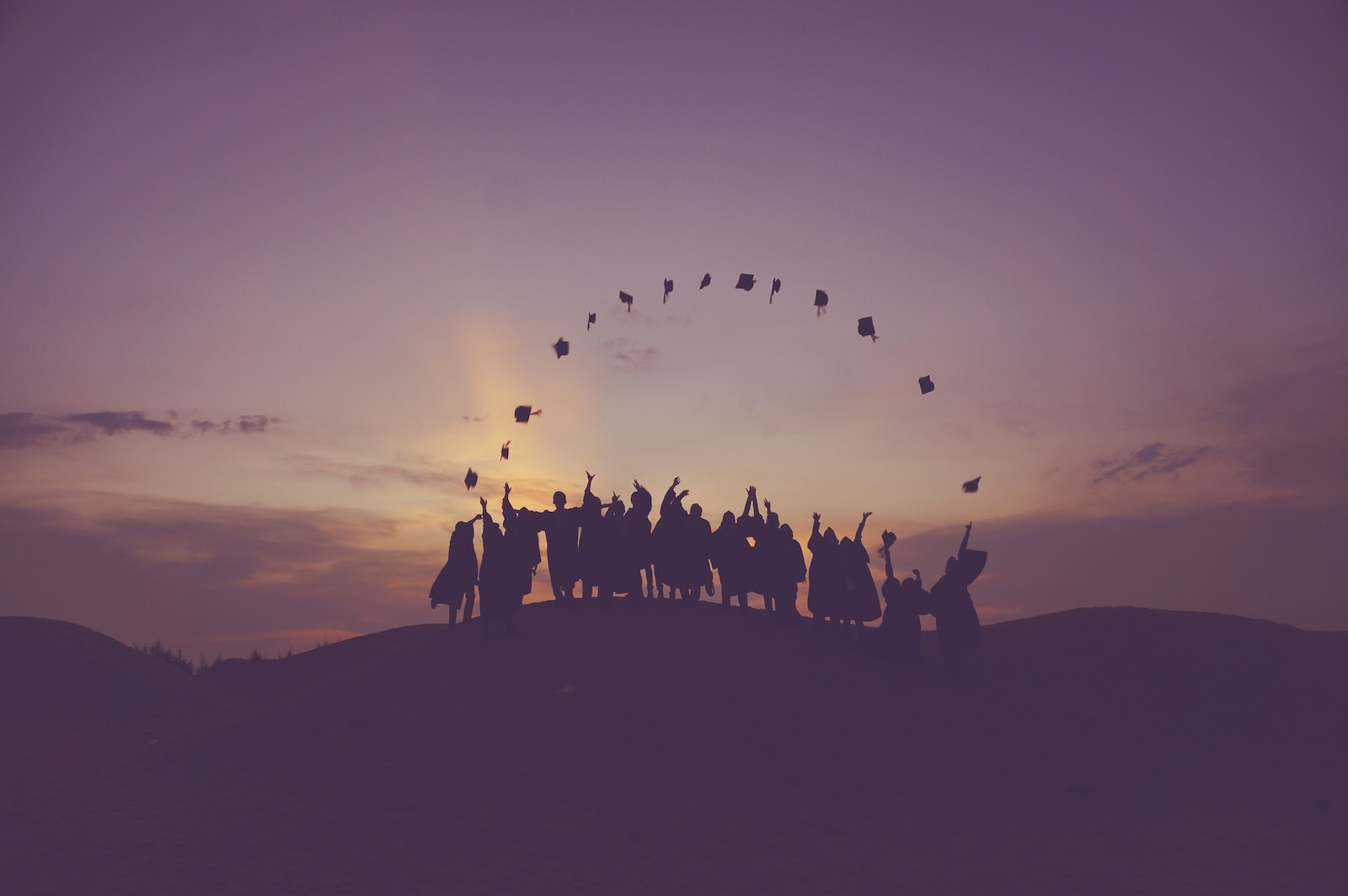 Students throwing graduation caps in the air