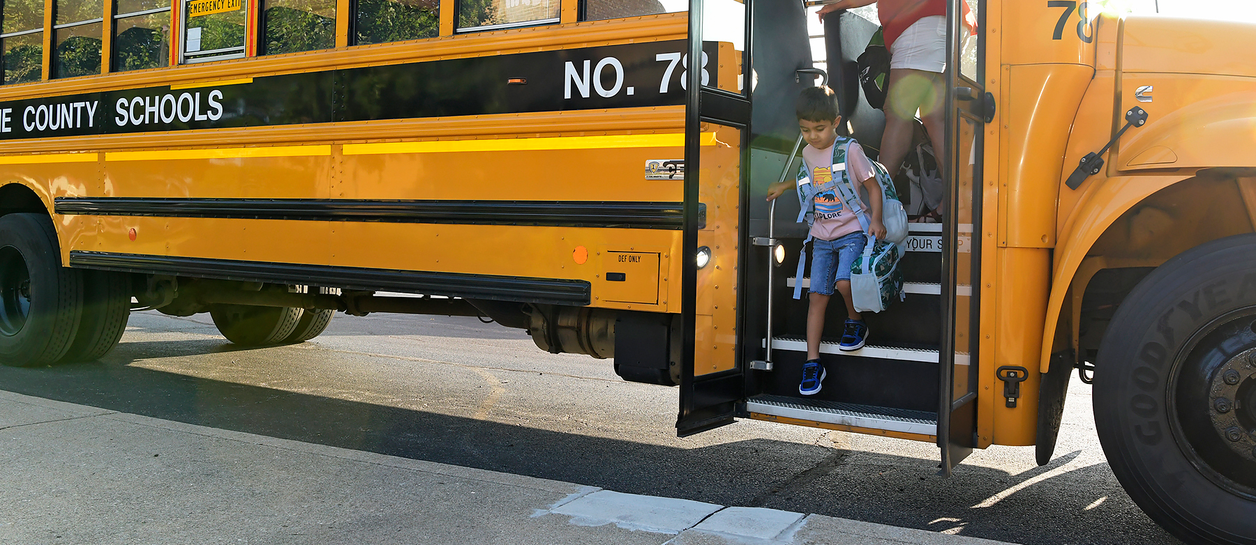 student getting off bus