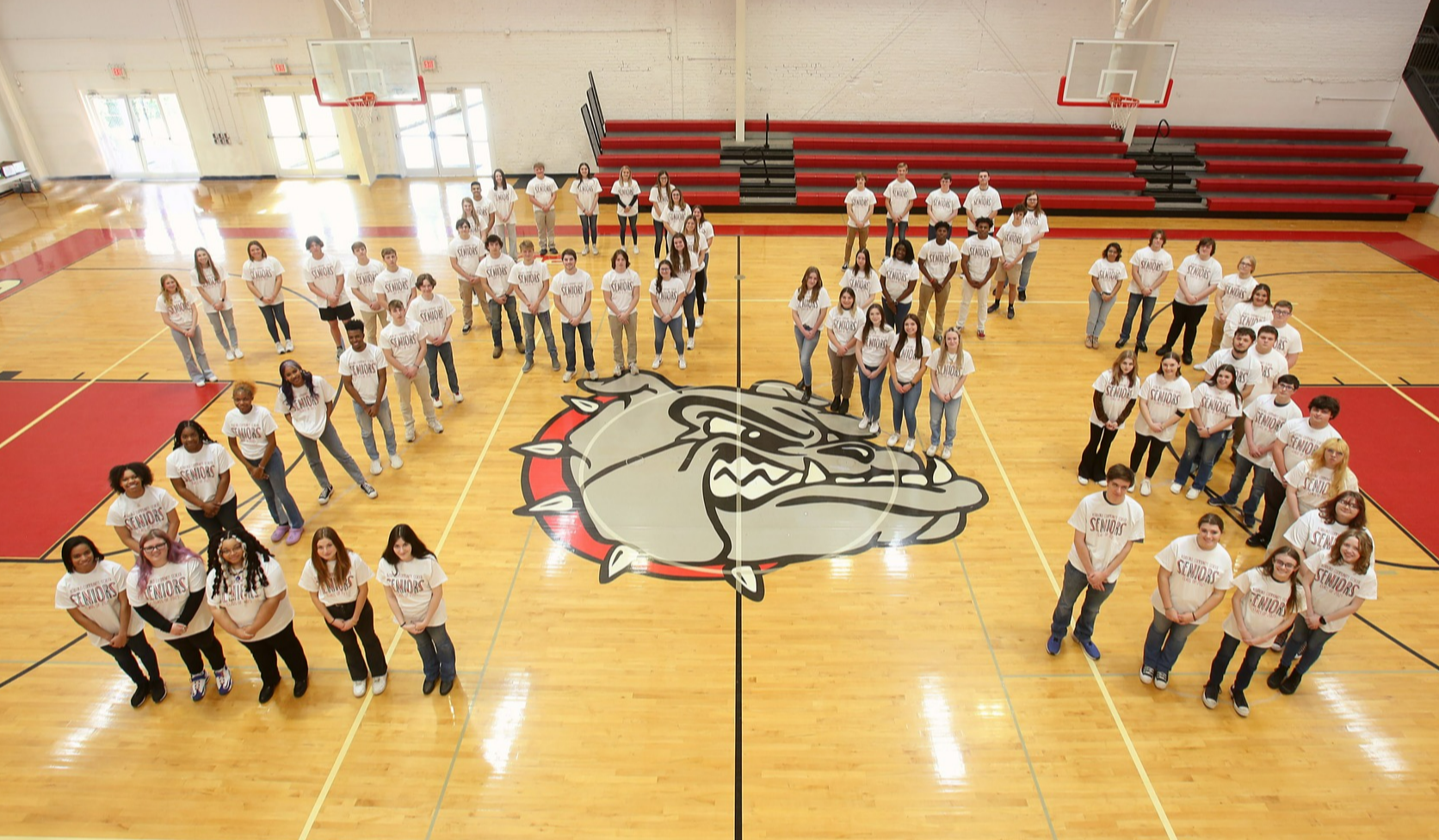 Students in the class of 2023 pose in white t-shirts and for me the number 2022