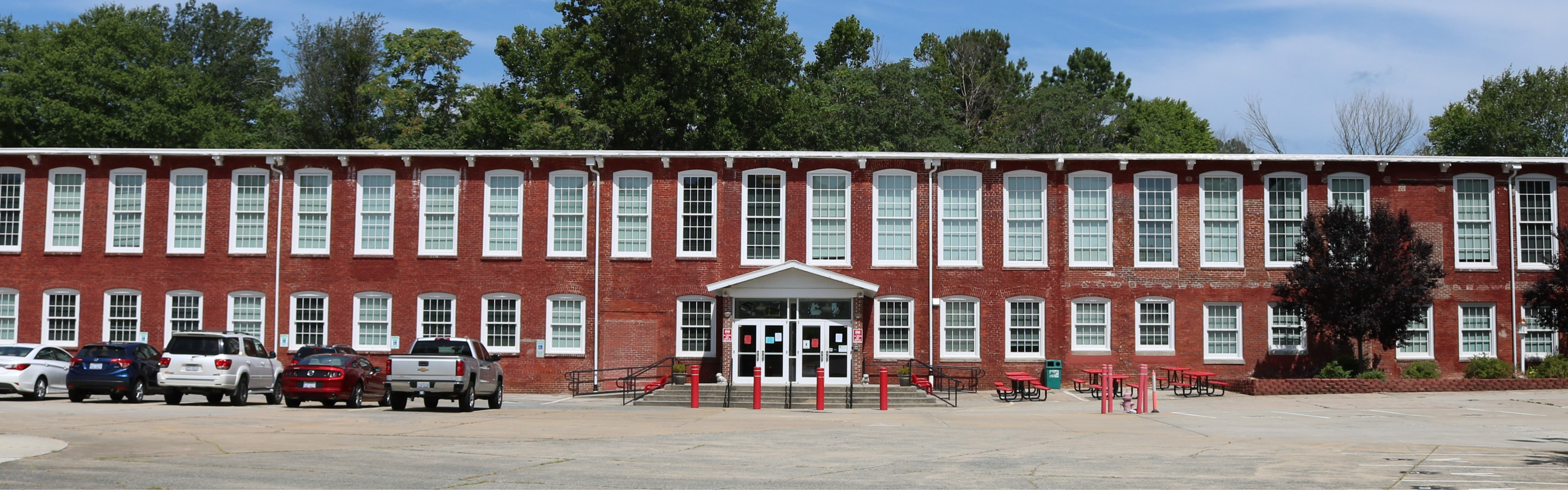 The front of RCS with cars parked to the left of the front doors