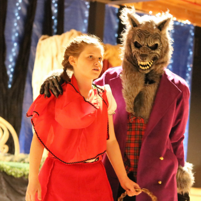 Students perform Into the woods: a wolf approaches a girl