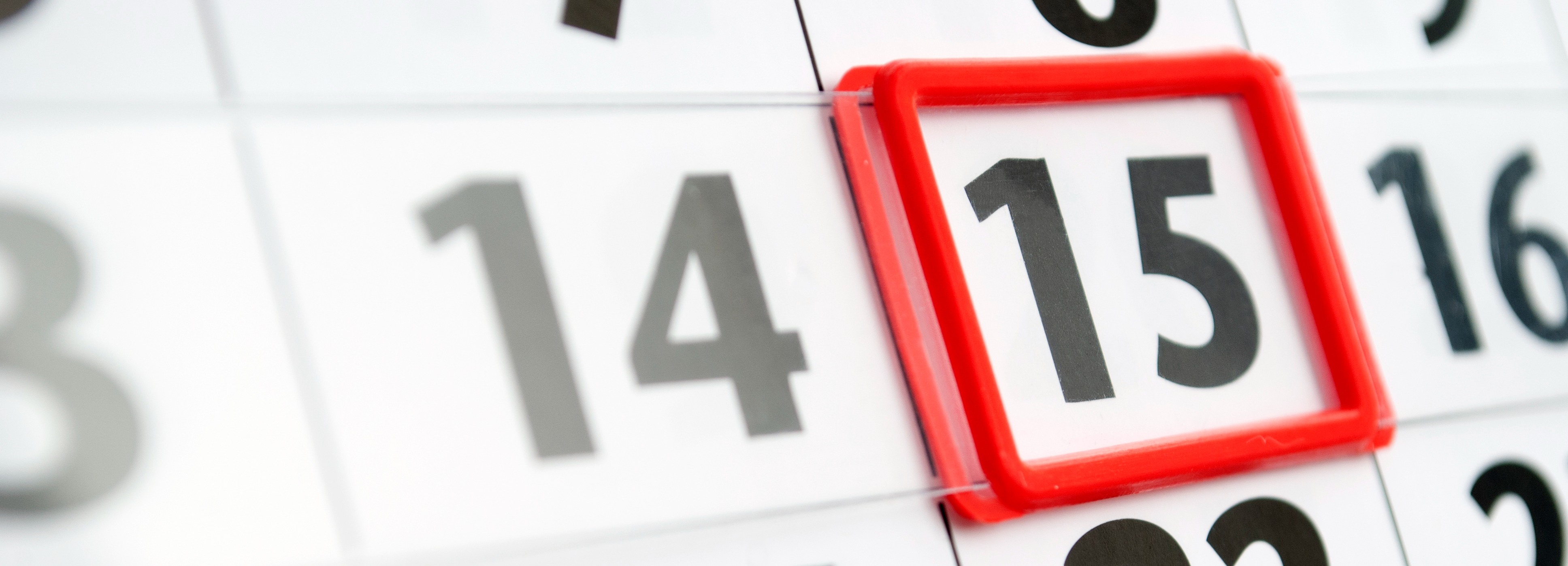 Close-up of a calendar page with the number 15 prominently framed by a raised rectangular border. Surrounding dates, including 14 and 16, are partially visible. The image emphasizes scheduling, planning, or marking an important date.