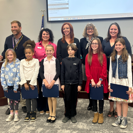 Runyon students pose with the LPS Board of Education for the Student Spotlight