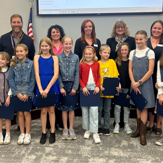 Runyon fifth graders stand with the Board of Education for the Student Spotlight.