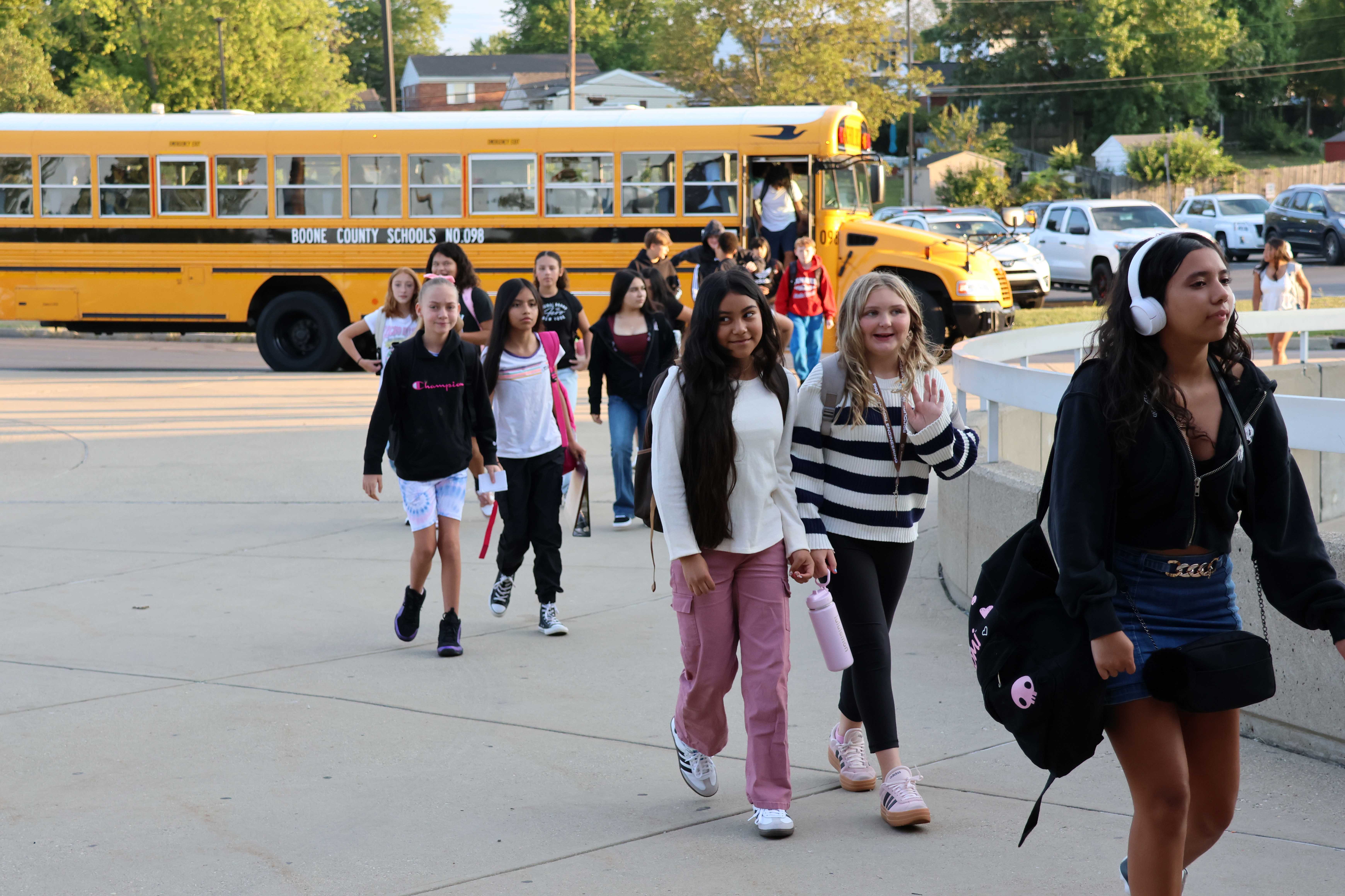 students getting off of buses
