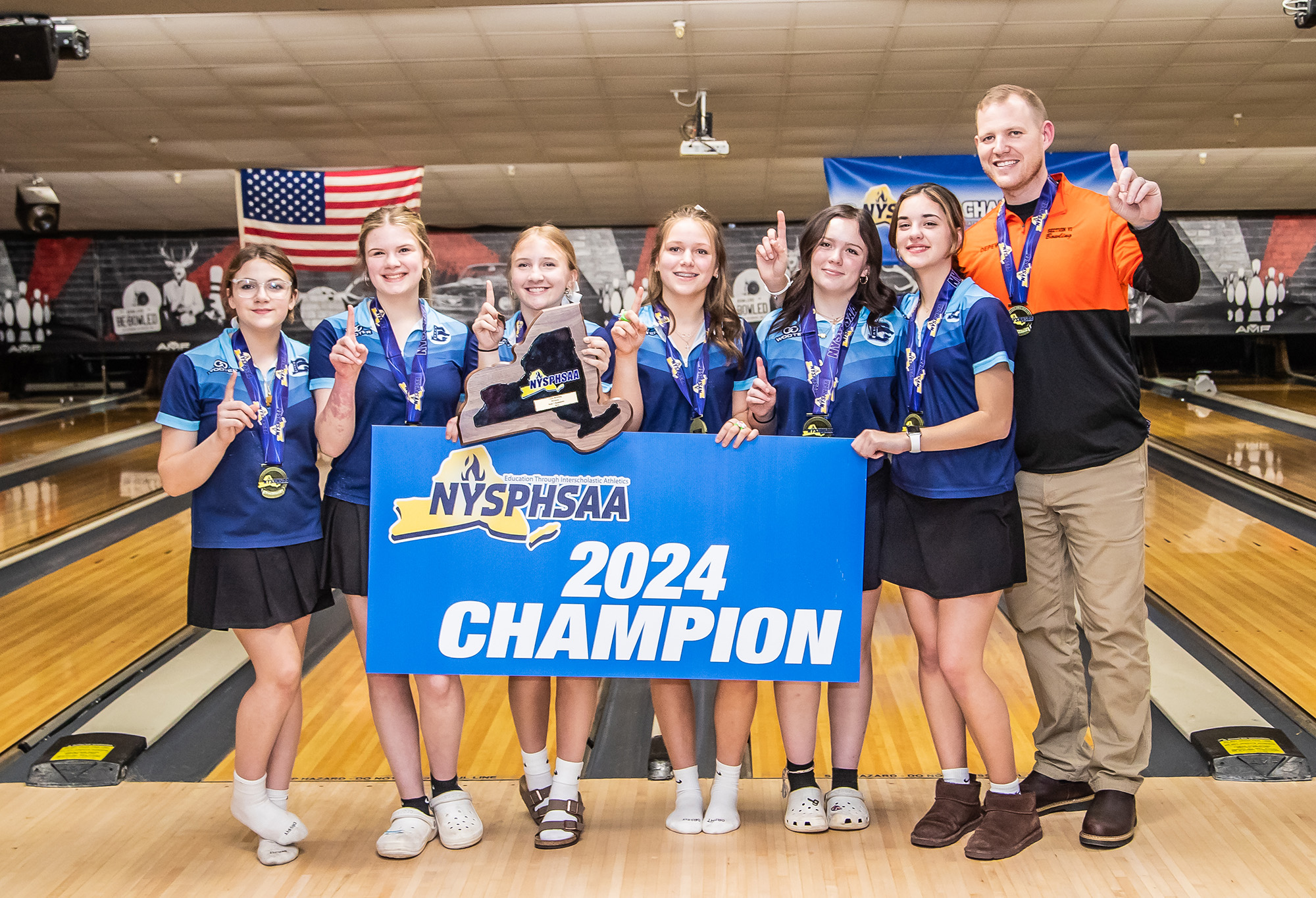bowling team poses with 2024 sign