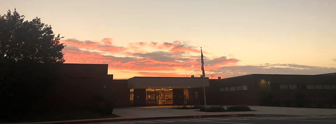 Front of school at sunrise.