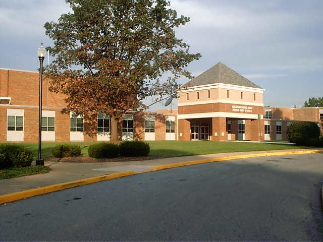 A large brick building featuring a prominent sign displayed on its facade.