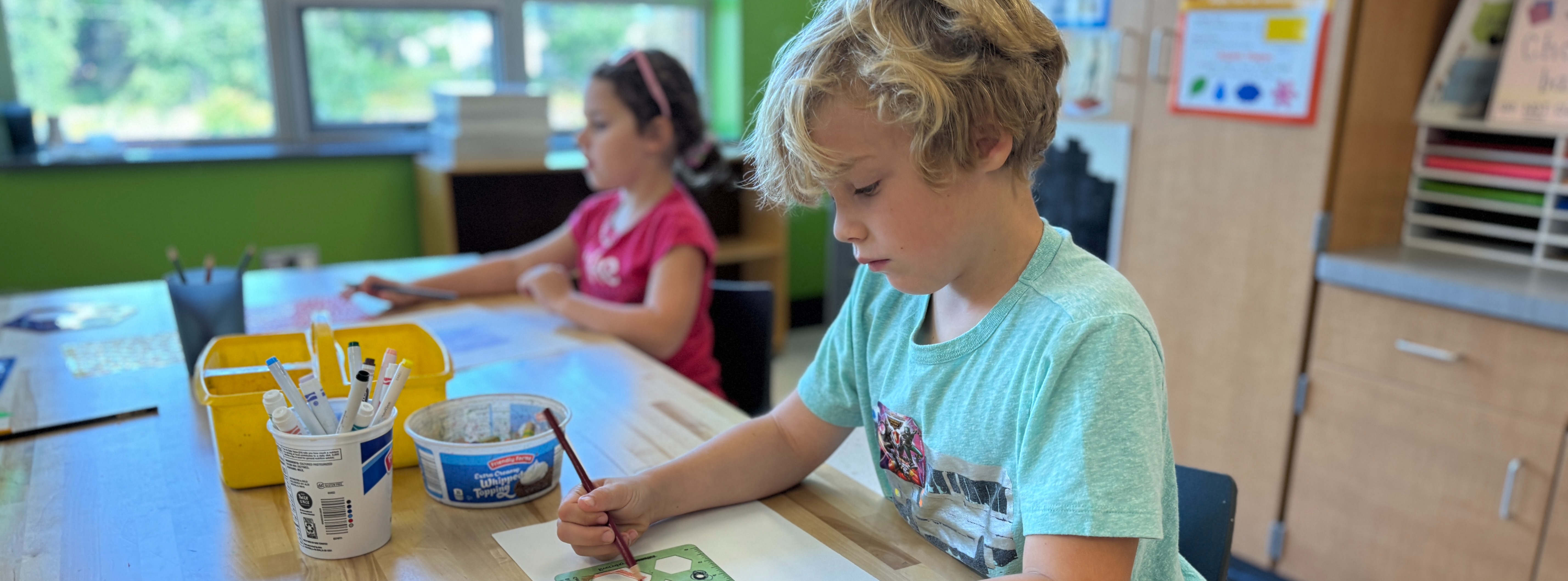 Elementary students working on art projects.