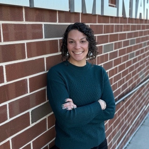 picture of principal in front of school