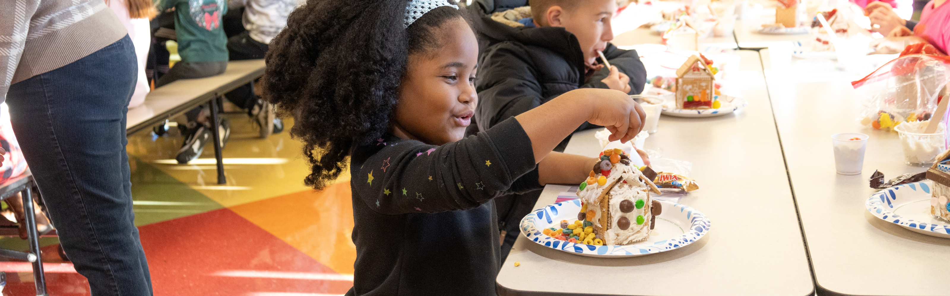 Girl building a ginger bread house