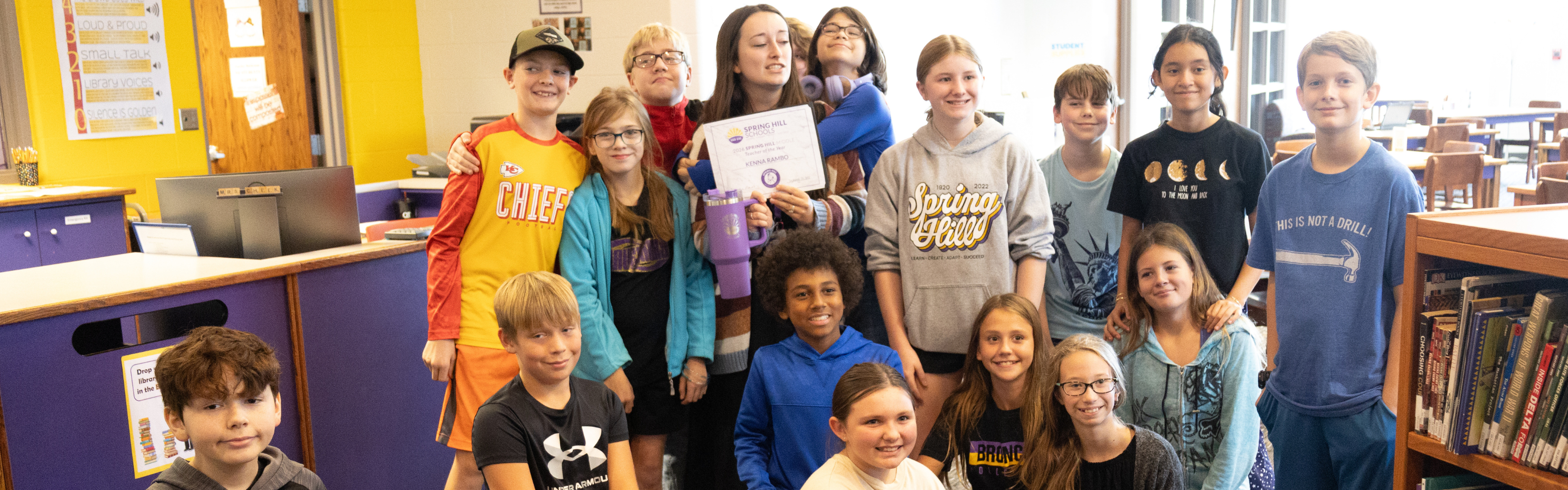 Image of students with their teacher receiving a Standing Ovation award