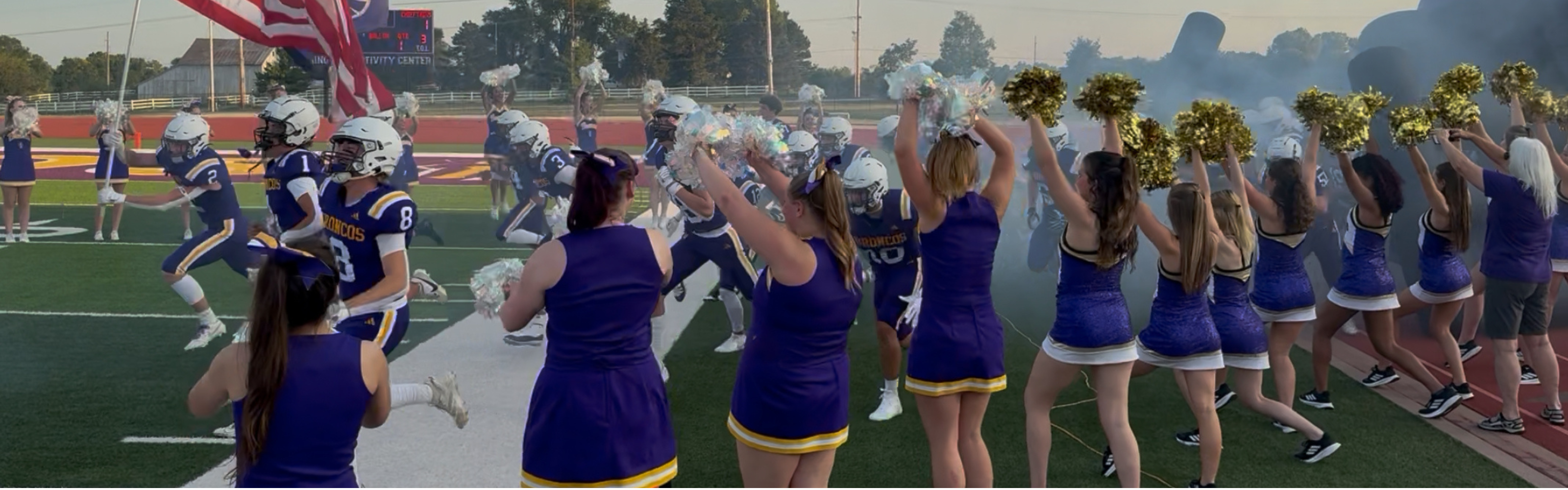 Football players and cheerleaders entering game