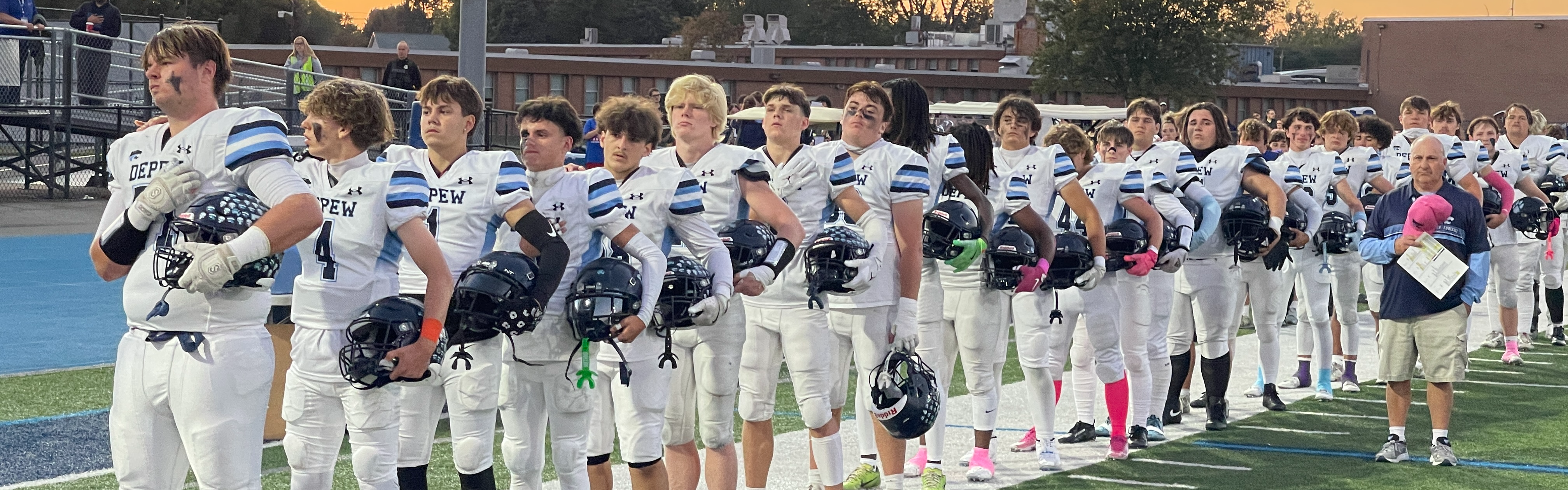 football players lined up during national anthem