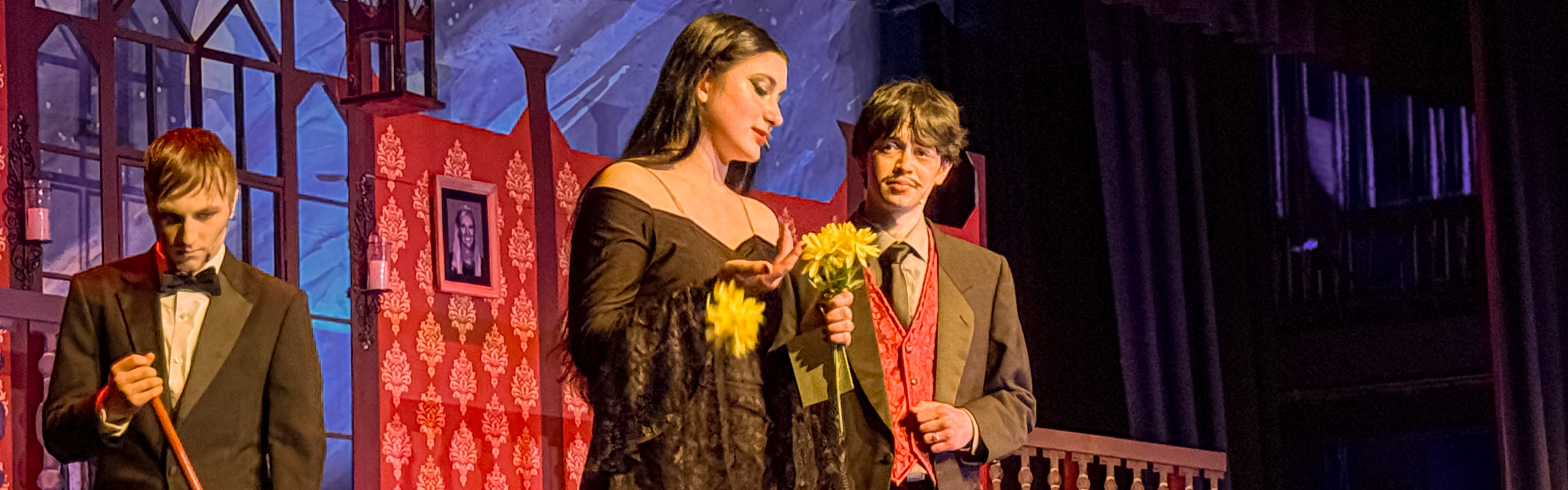 the addams family, morticia, gomez and lurch on stage during musical performance