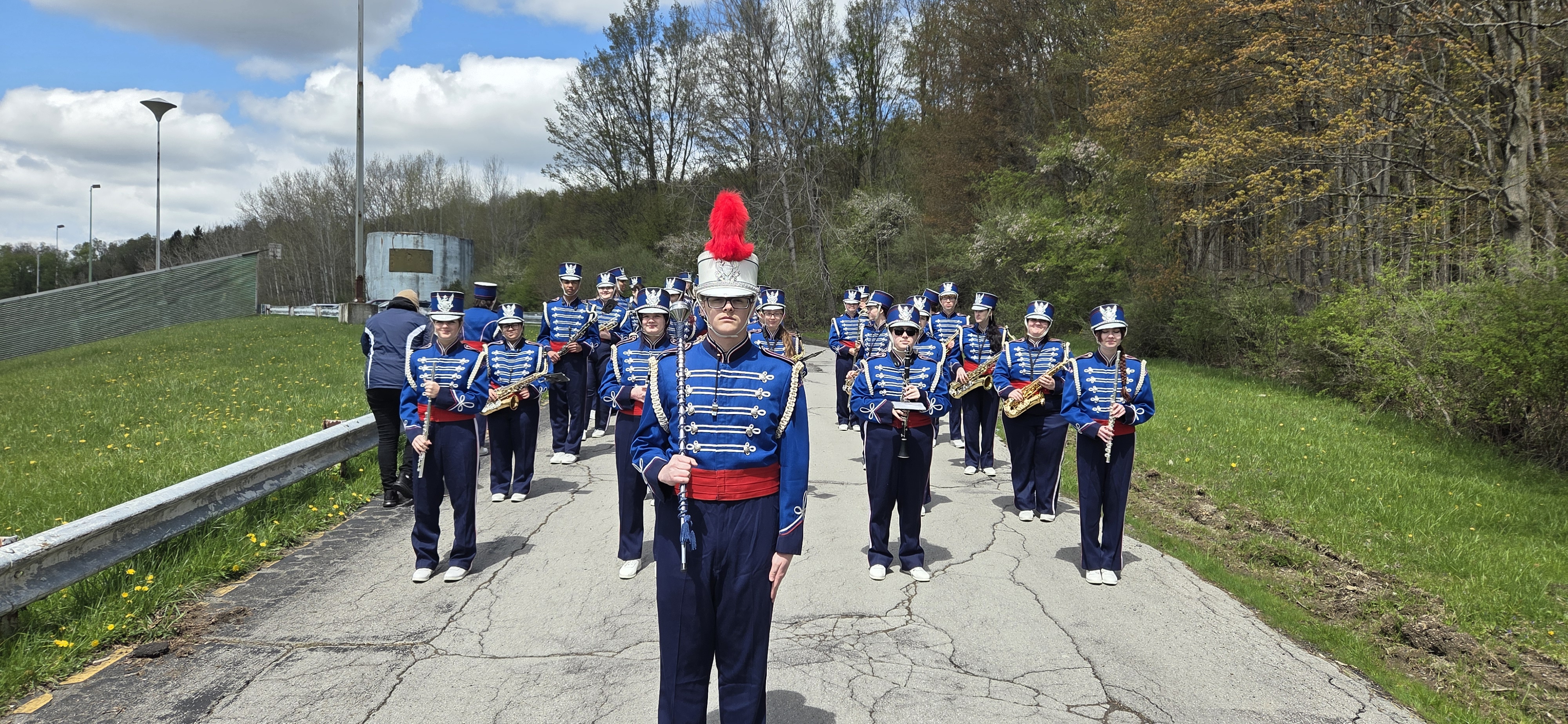 marching band standing in formation in road