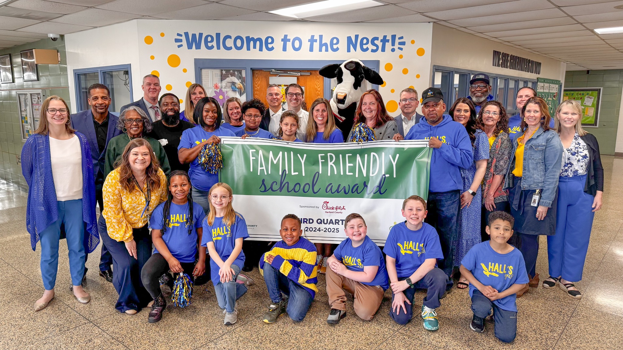 Hall's Cross Roads staff and students holding the Family Friendly banner