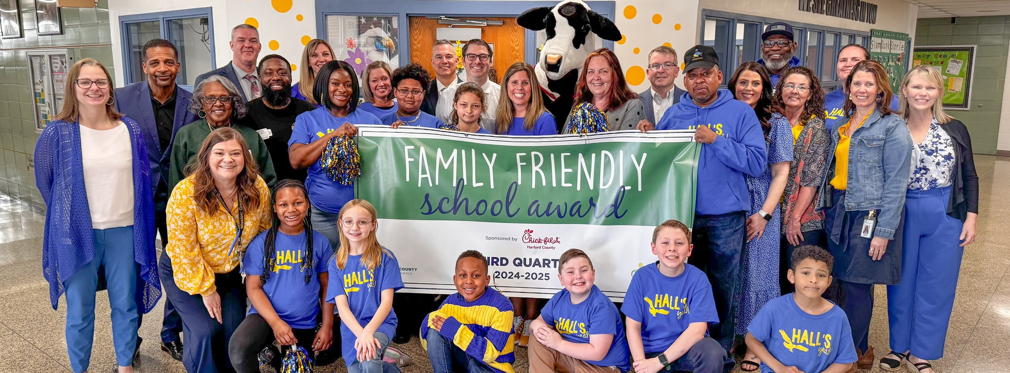 Hall's Cross Roads staff and students holding the Family Friendly banner