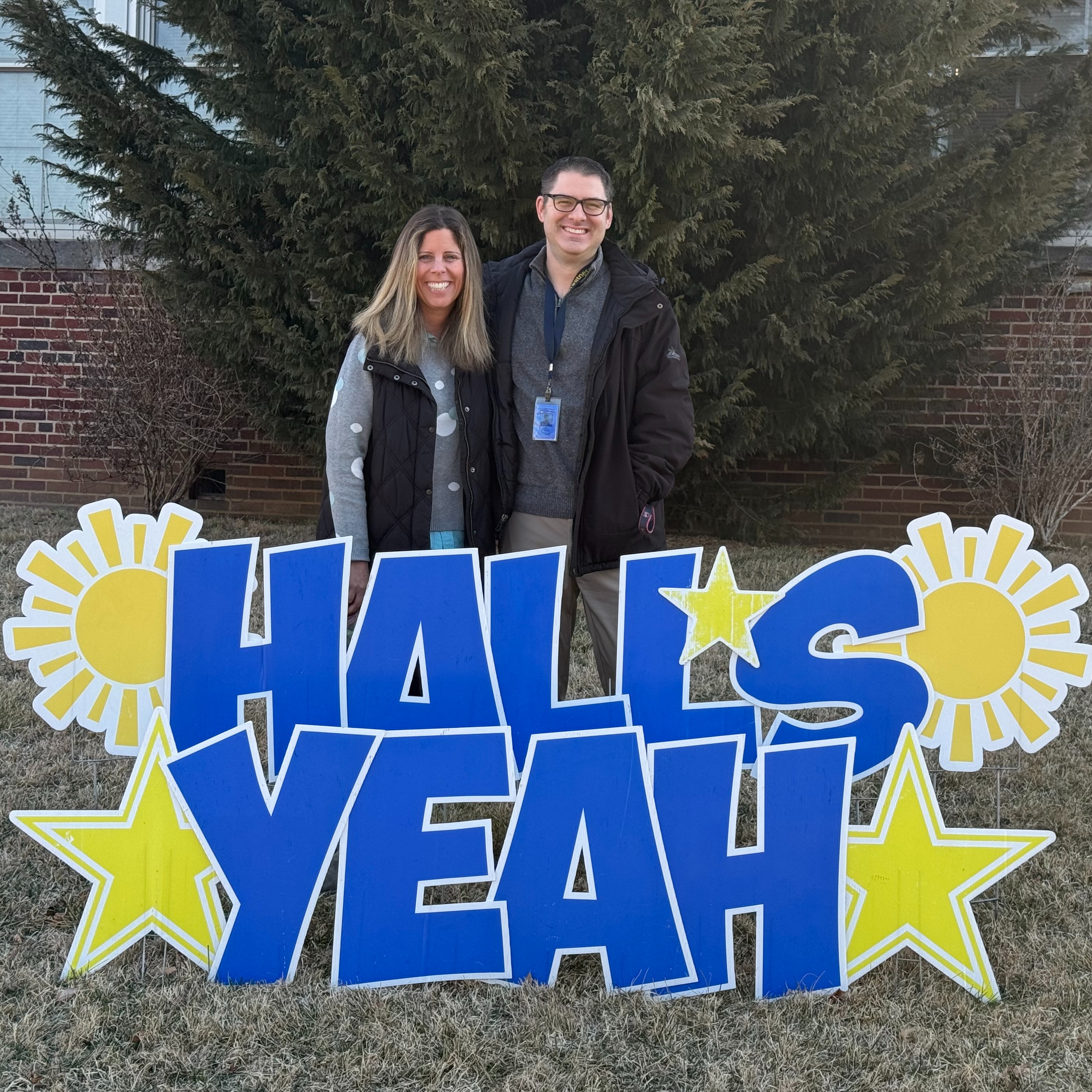 Mrs. Jankowiak & Mr. Gipprich with a Hall's Yeah sign