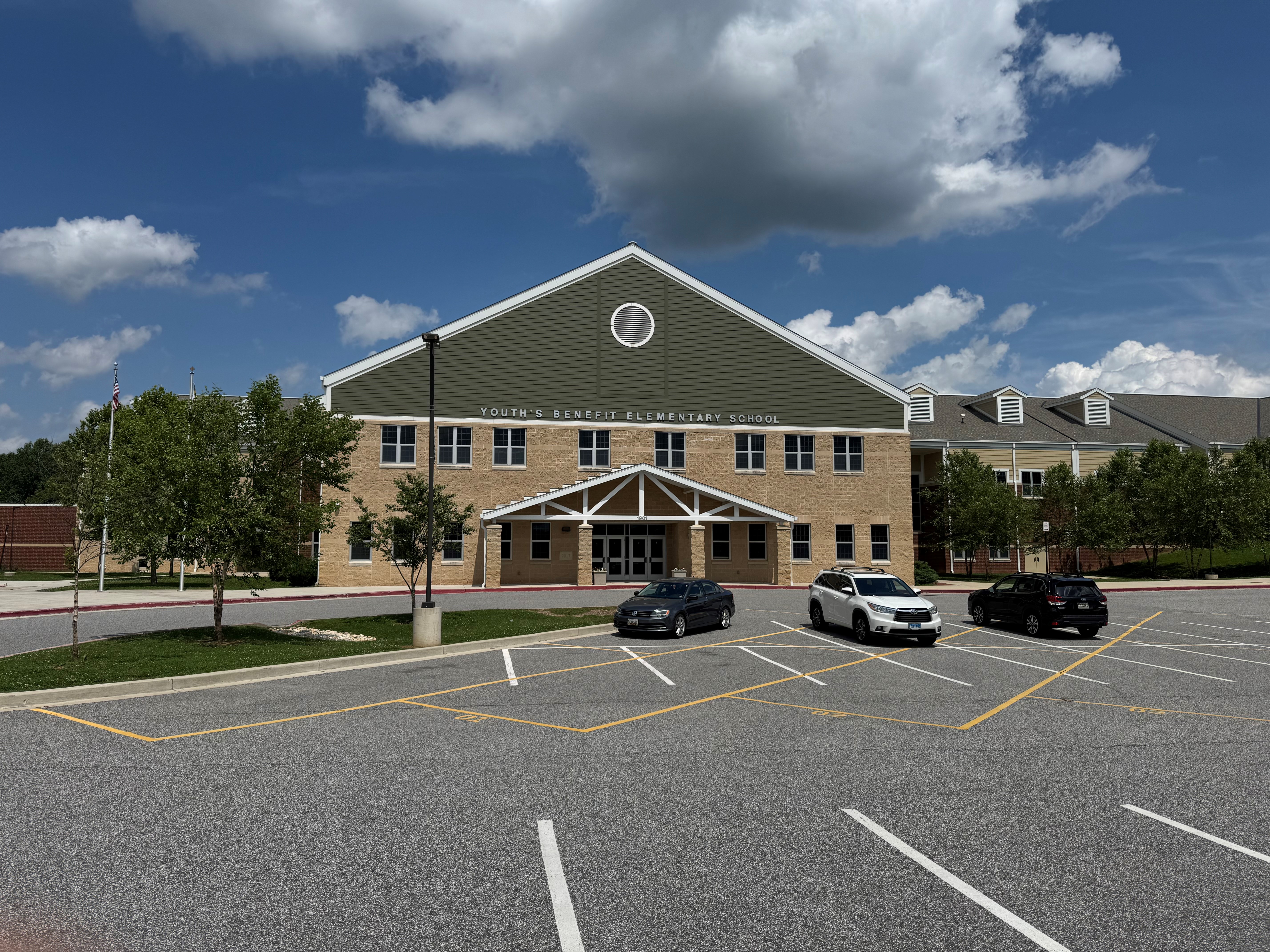 Front of Youth's Benefit Elementary School with a blue sky above